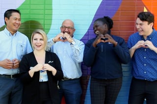 smiling-bwalk-team-showing-love-hand-signs-crop