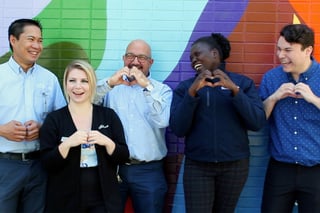 smiling-bwalk-team-showing-love-hand-signs-crop