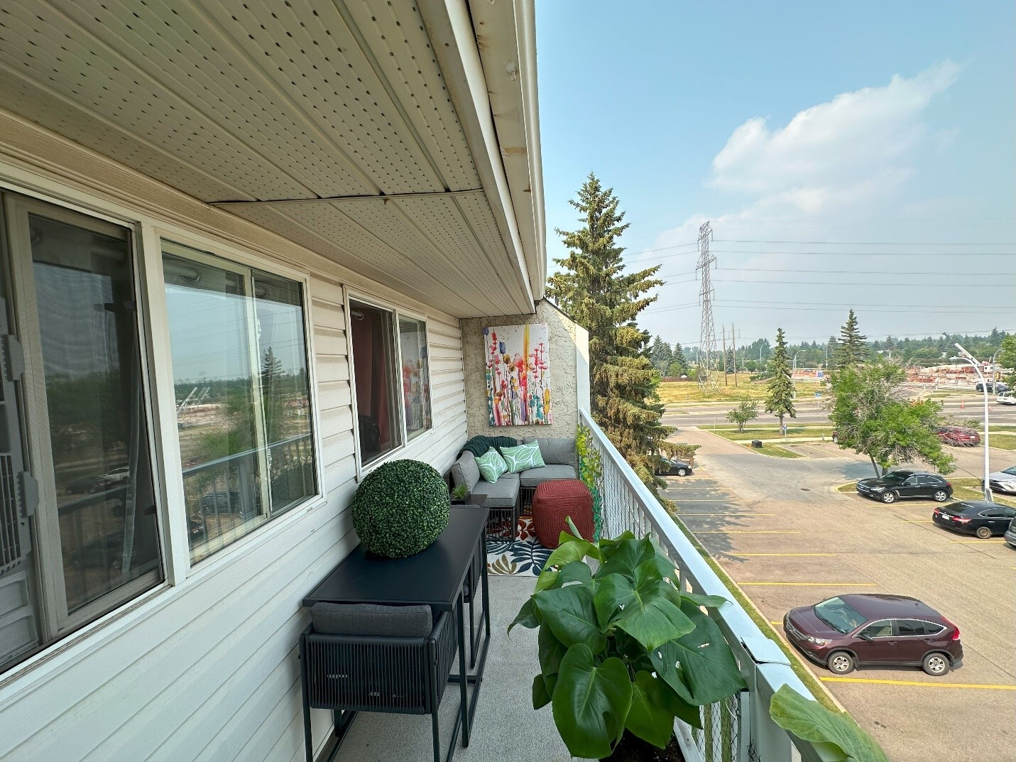 A balcony with a view of a parking lot and cars

AI-generated content may be incorrect., Picture